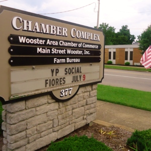 A sign that says "Chamber Complex, Woster Area Chamber of Commerce, Main Street Wooster, inc, Farm Bureau" 