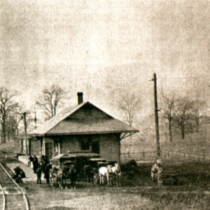 Carriages standing beside the Wooster train station. 