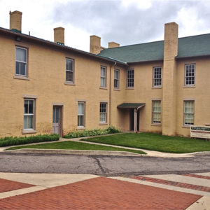 A colonial-era two story yellw brick house.