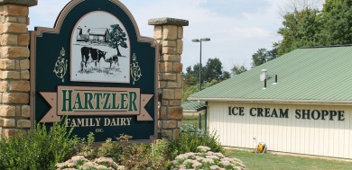 The sign for Hartzler's dairy that is outside of the ice cream shop. 