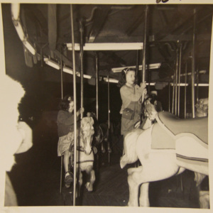 Children riding a merry-go-round. 