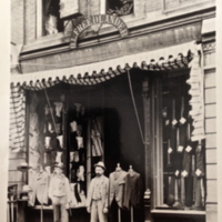 Men standing outside of a storefront, 