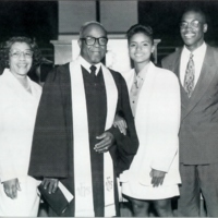 Reverend Leroy Adams standing with his wife and his children. 