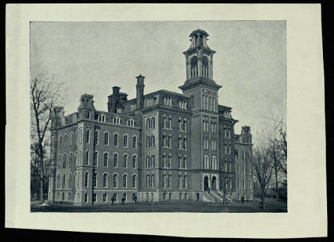 A photograph of Old Main from the 1800s. Old main was a 4-floor large brick building with one large tower and several chimneys. 