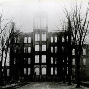 a front view of Old Main after the fire, where only the frame of the building remains. 