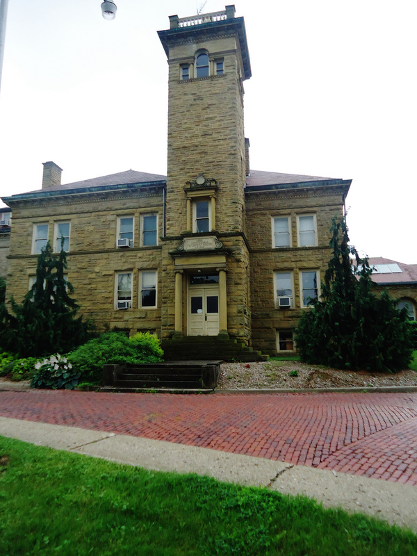 Frontal view of the first administration building on the OARDC Wooster campus, which is a large brick building with a tower. 