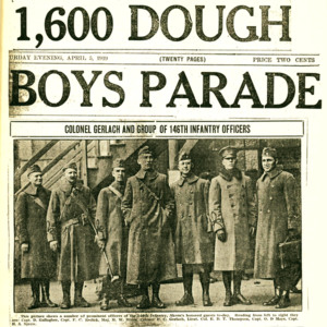 Excerpt from a newspaper with the headline. "1,600 dough boys parade" with a photograph of several young men posing in military uniforms on a city street. 