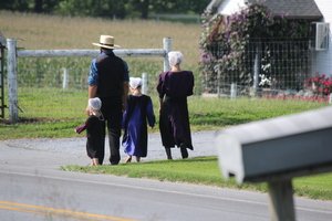 An amish family walking along a road 