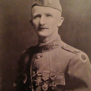 Portrait of a man in a military uniform wearing several medals. 