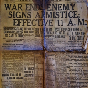 Excerpt from the Akron Beakon Journal with the headline "War ends, enemy signs armistice, effective 11 A.M." 